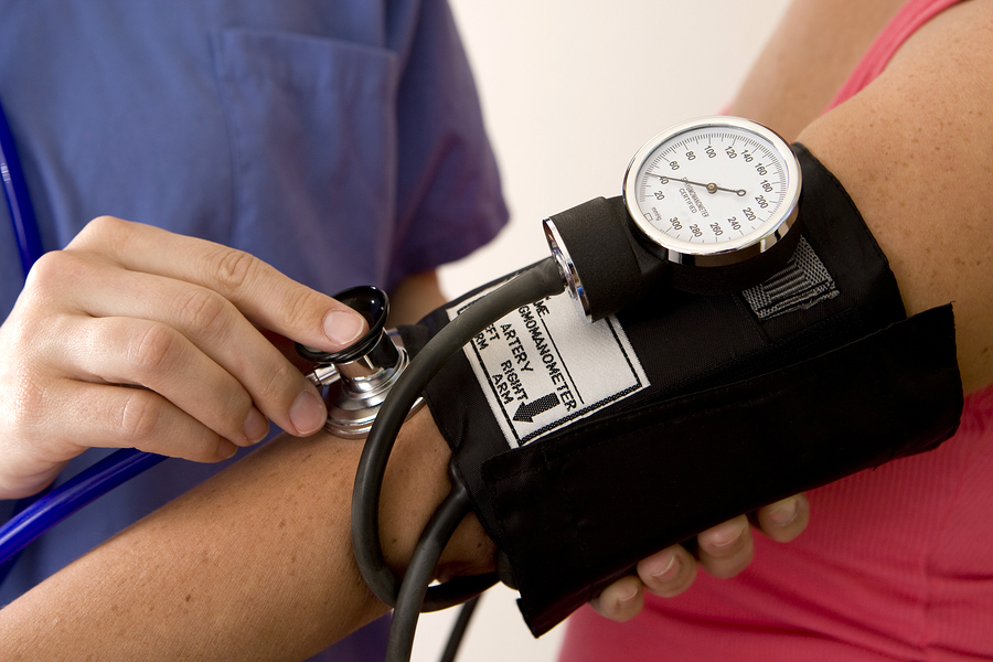 A nurse takes a person's blood pressure with a pressure sleeve.